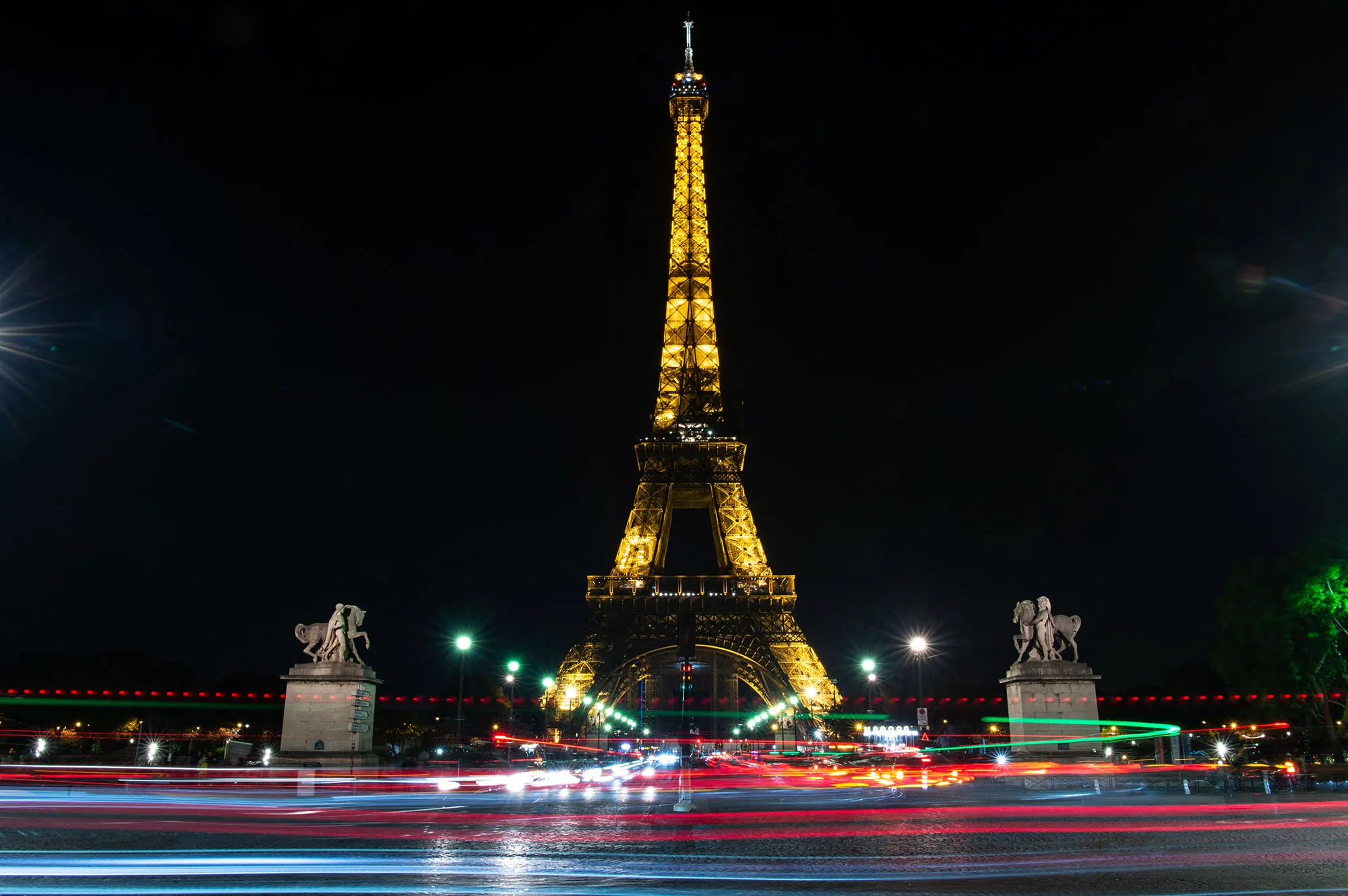 The Eiffel Tower sparkling at night against the Paris skyline